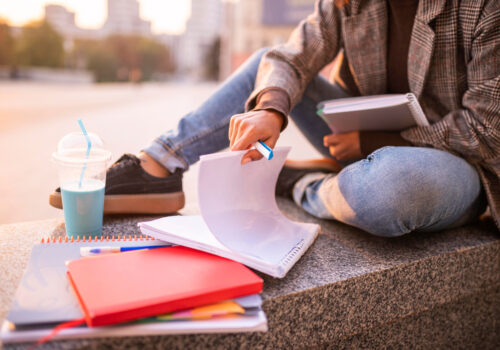 woman-doing-homework-outdoors-city-1.jpg